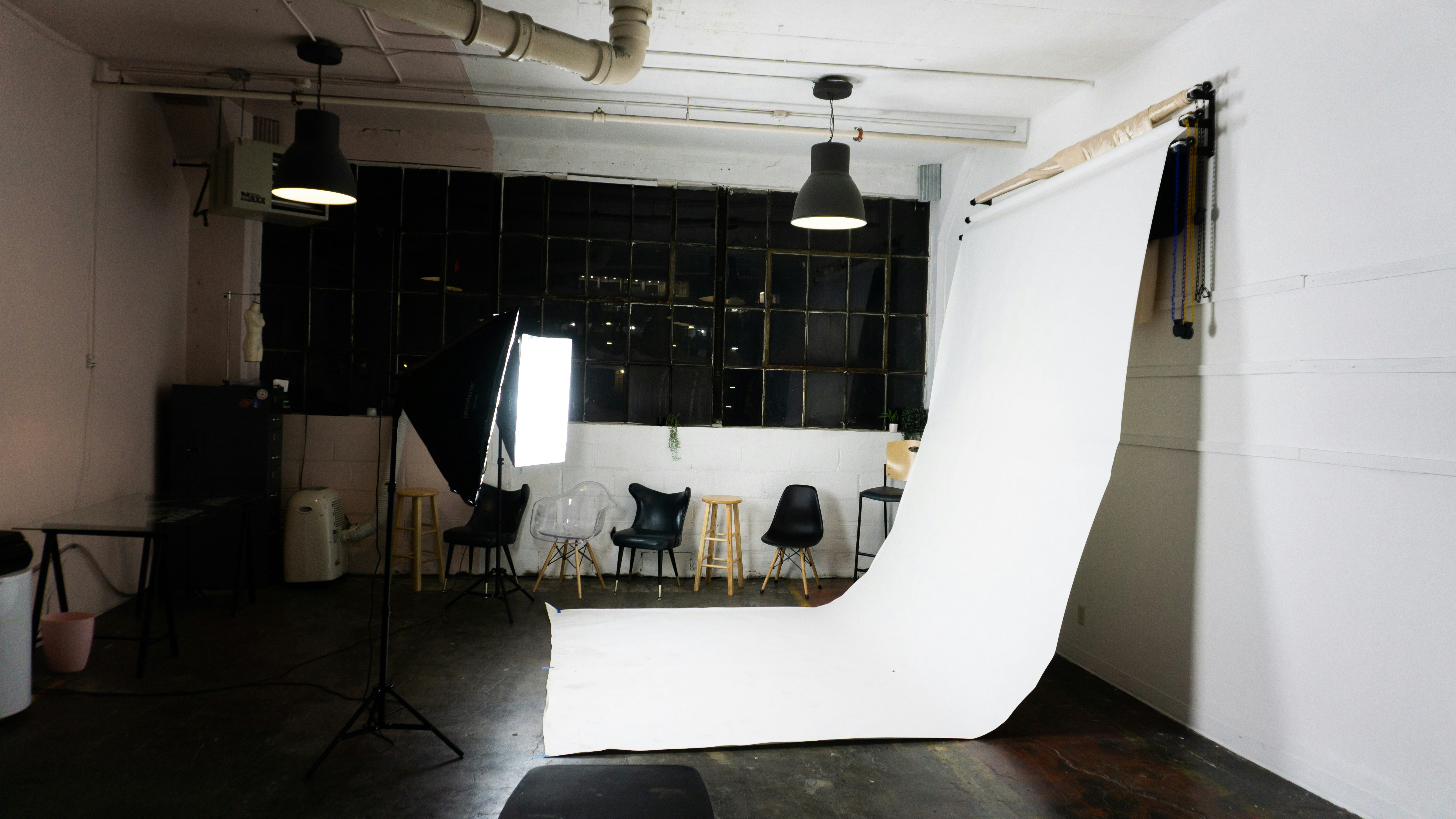 A professional photography studio setup with various backdrops, studio lights, and camera equipment arranged neatly for a photoshoot